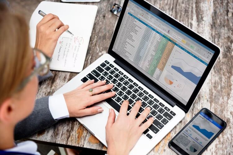 Data-Driven Insights for Better Decision-Making A Professional Analyzing Fuel Station Sales and Inventory Data on a Laptop, Optimizing Business Operations