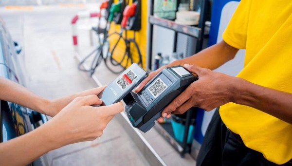 Gas Deck: The Ultimate Solution for Gas Station Management & Rewards A Customer and a Gas Station Attendant Using QR Code-Based Mobile Payment at a Fuel Station
