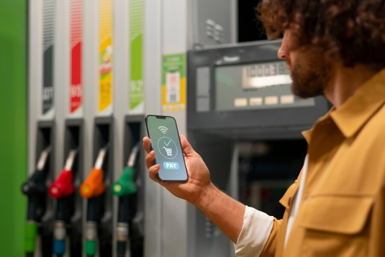 Seamless Payment Processing for Faster Checkouts A Customer Using a Smartphone to Make a Digital Payment at a Gas Station Fuel Pump