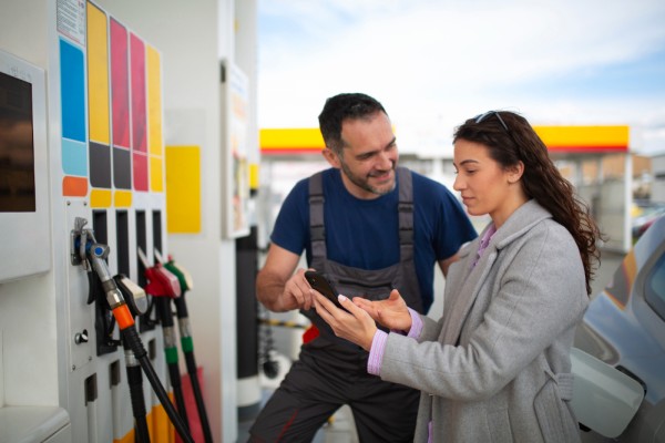 Gas Station Customer Making a Purchase at the Counter, Showcasing a Loyalty Program