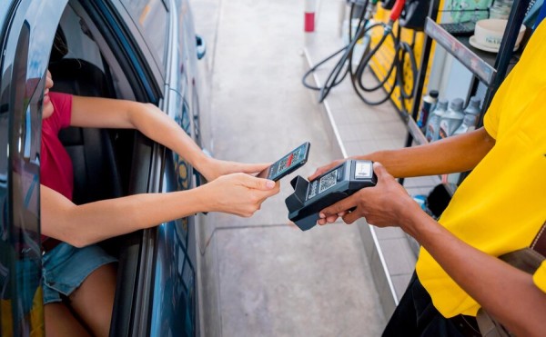 Gas Station Contactless Payment for Ultimate Convenience A Customer Making a Contactless Payment from Their Car at a Gas Station Using a QR Code Scanner