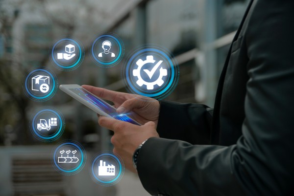 Inventory Management : Never Run Out of Stock A Businessman Using a Tablet with Digital Icons Representing Logistics, Inventory, and Automation
