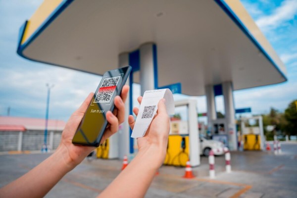 A Customer Near Gas Station Scanning a QR Code