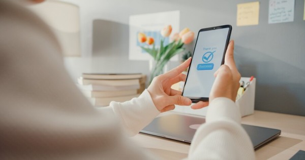 Person Analyzing Sales and Performance Reports on a Laptop Screen