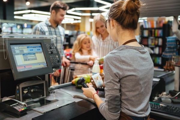 Simplify Store Sales Management Cashier Using a POS System to Scan Groceries While a Family Waits