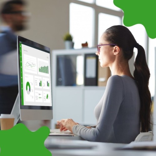 Best Back Office Software for Gas Station: Keeping Everything Running Behind the Scenes A Person Working at a Desk, Analyzing Data on a Computer Screen Displaying Graphs and Charts in a Modern Office Setting