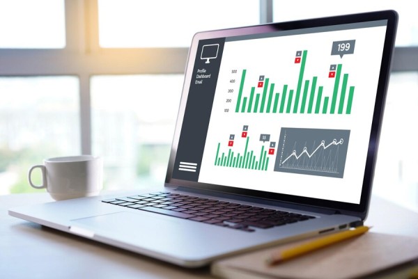 A Laptop Screen Displaying an Interactive Dashboard with Fuel Station Performance Metrics and Transaction Insights